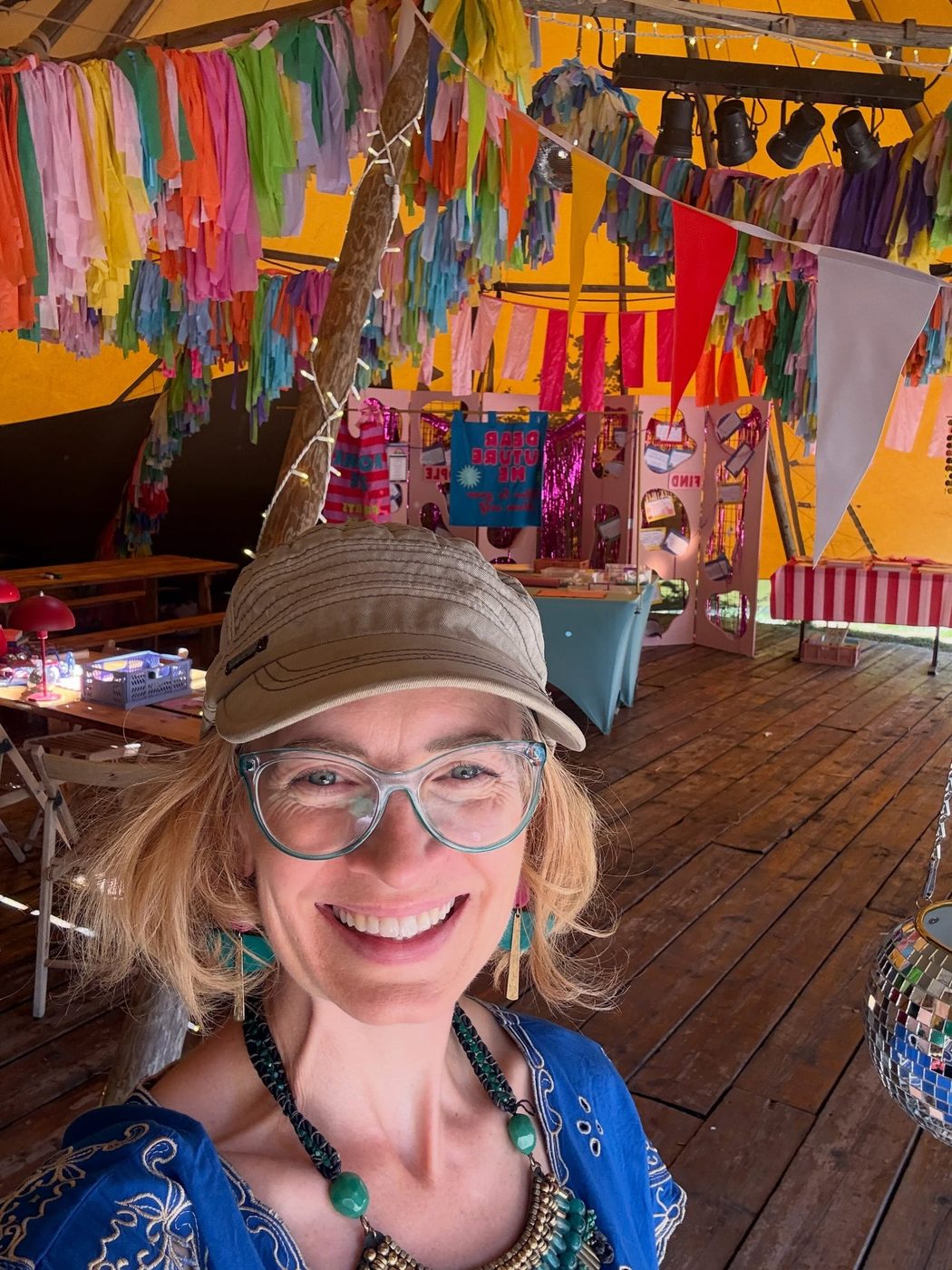 Sarah at a festival, wearing a cap