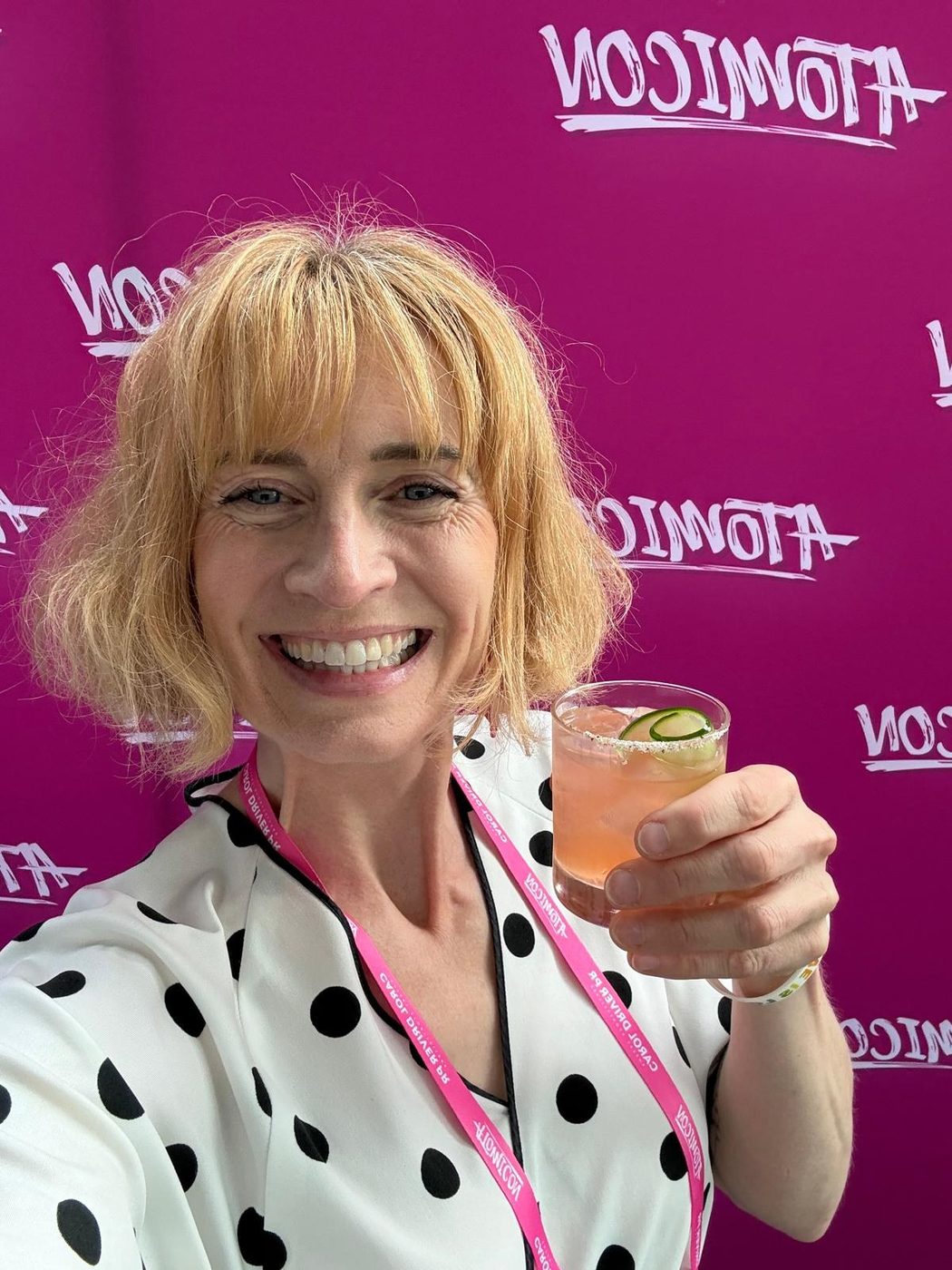 Sarah raising a cocktail at ATOMICON